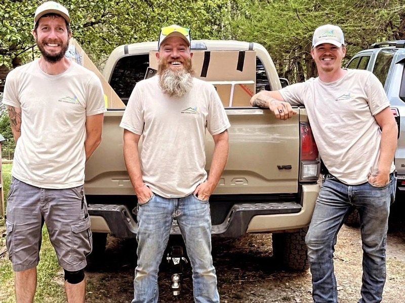 Three WNC Climate Control HVAC technicians standing by tan work truck in Weaverville NC
